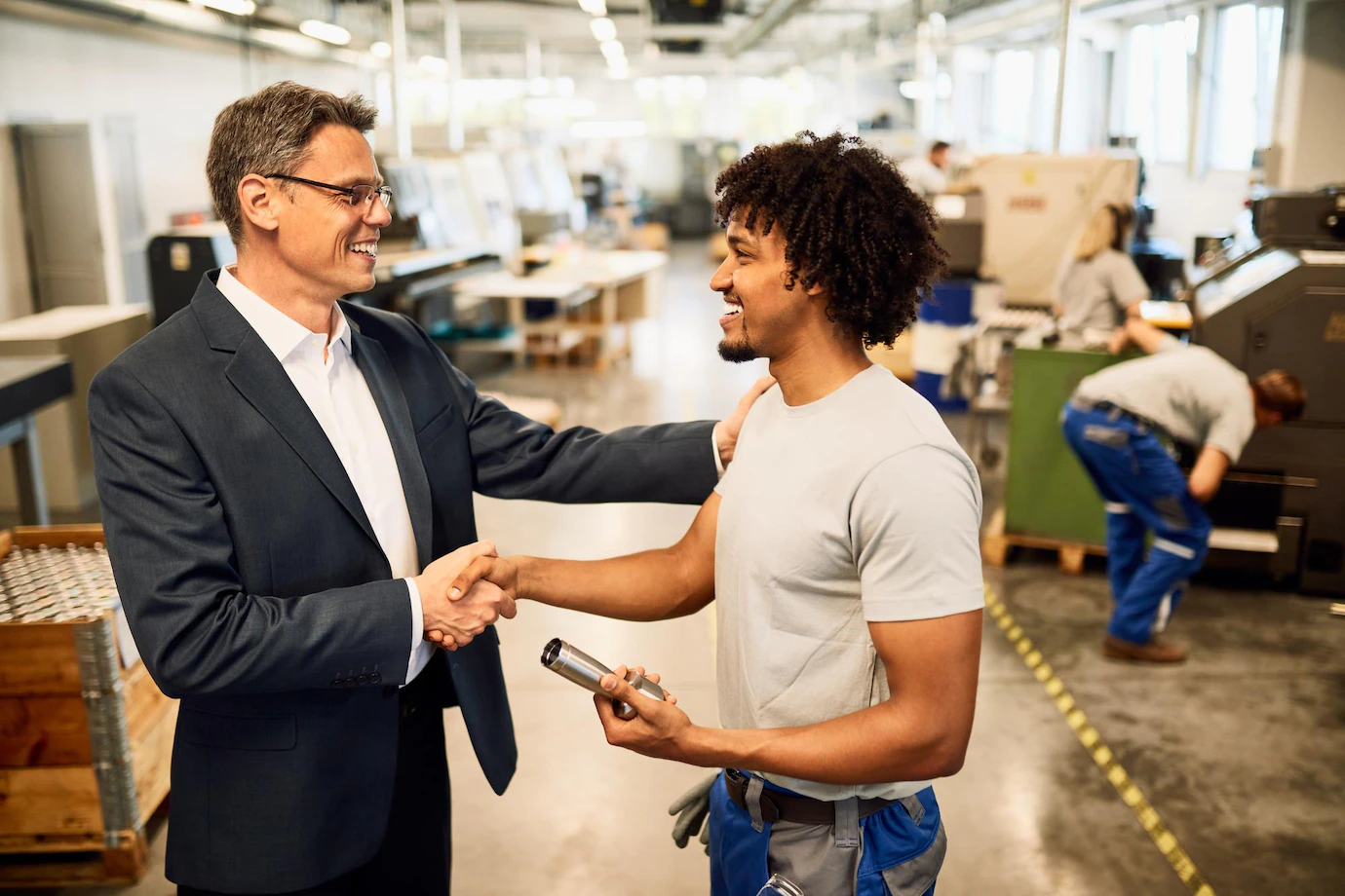 happy-manager-shaking-hands-with-african-american-factory-worker-industrial-building_637285-4774