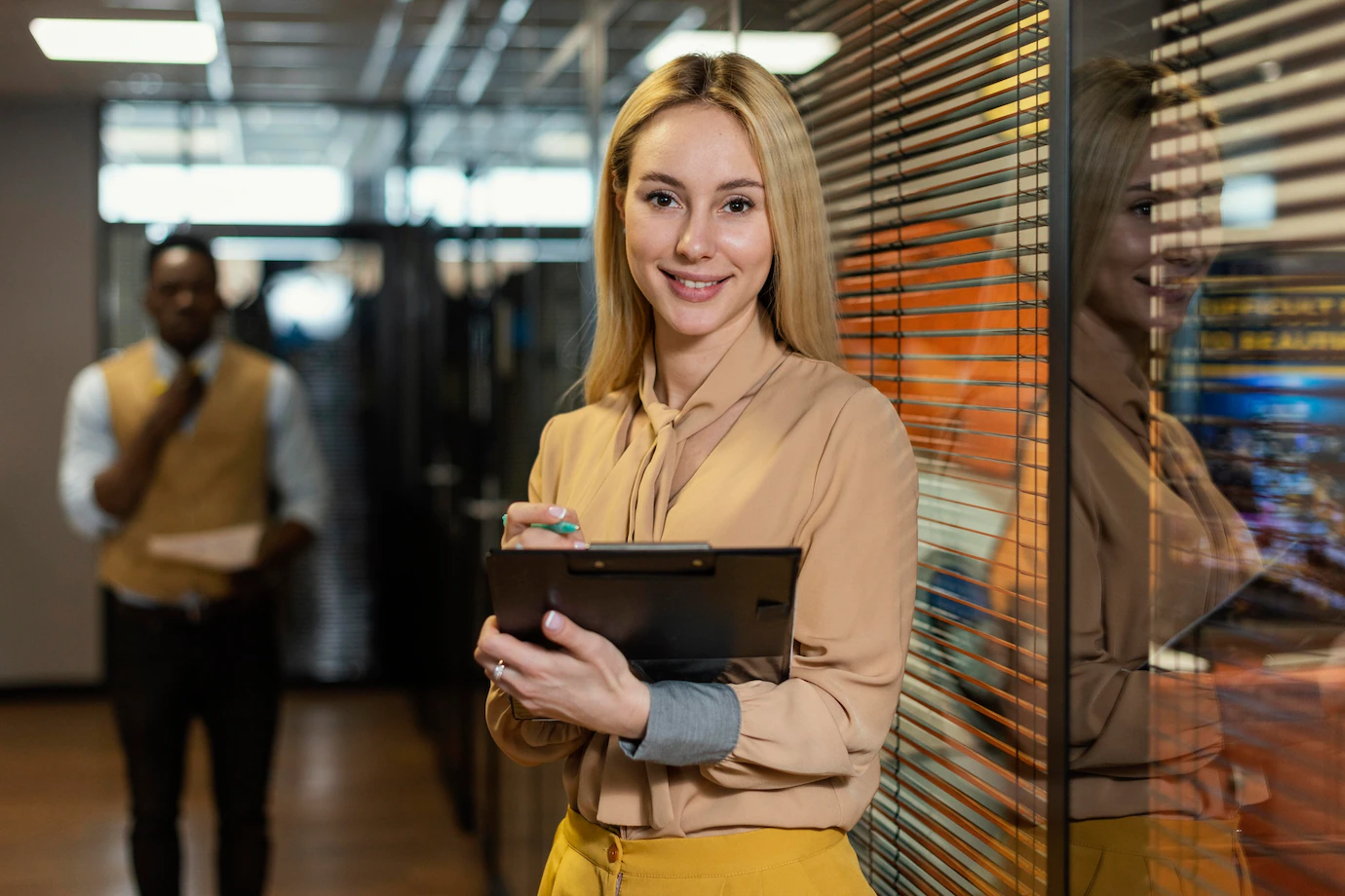 smiley-woman-holding-clipboard-workplace_23-2148908807